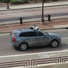 grey car driving on the road with hi-tech attachment on top